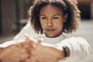 Woman stretching before a run in the city