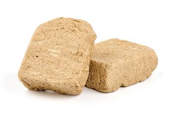 Pieces of sunflower halva, isolated on white background.