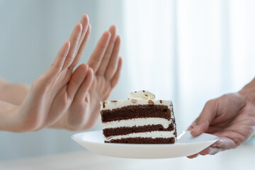 Beauty slim female body confuse chocolate cake. Woman in restaurant achieves weight loss goal for healthy life, crazy about thinness, thin waist, nutritionist. Diet, body shape.