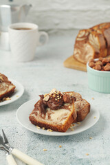 A piece of marble biscuit with chocolate cream and nuts