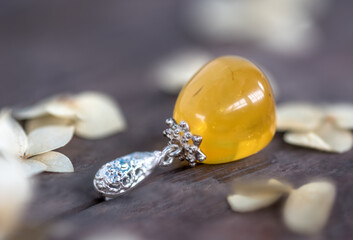 Silver pendant with amber. The stone is cut by hand. The stone can range from yellow and honey to dark burgundy. May include milky streaks and inclusions.