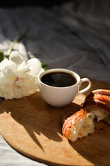 coffee and croissant in the bed with peony