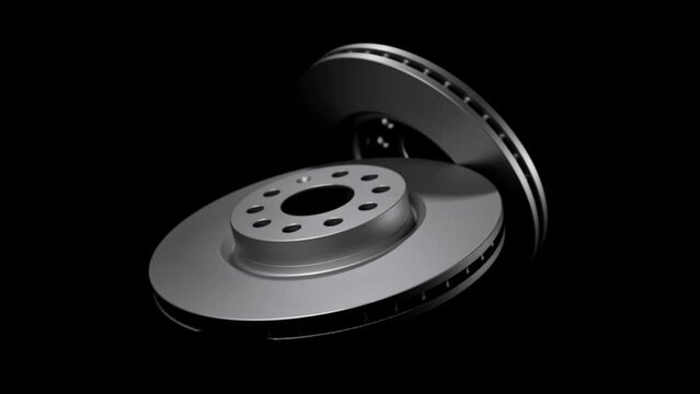 New automotive disc brakes for auto wheel. Pair of rotor braking disks isolated in dark studio, black background. Auto spare parts closeup. Clean vehicle metallic equipment details for car transport