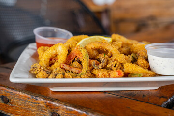 Fried calamari with jalapeno or chili. A fast food appetizer in the US. Calamaries are deep fried after being dipped in batter. Serve with blue cheese or spicy sauce and lime juice on the side. 