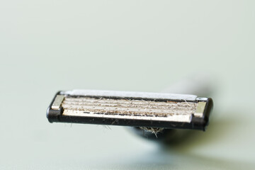 Dirty used razor blade. An example of unsanitary and unhygienic shaving. Macro. Selective focus....