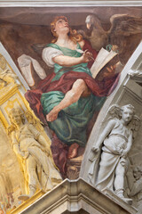 GENOVA, ITALY - MARCH 7, 2023: The fresco of St. John the Evangelist from cupola of the church Chiesa di san Pietro in Banchi by Paolo Gerolamo Piola from end of 17. cent.