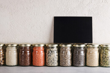 Zero waste lifestyle concept. Responsible consumption, healthy vegetarian food. black board for text on glass with food containing proteins and fats.