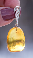 Silver pendant with amber. The stone is cut by hand. The stone can range from yellow and honey to dark burgundy. May include milky streaks and inclusions.