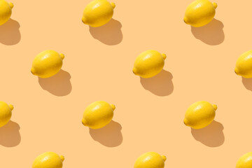 Lemon on yellow pastel soft color with long shadows. Minimal healthy organic food concept. Citrus fruits. Flat lay, top view