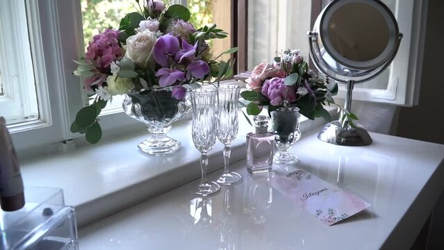 Indoor flowers in a vase on a sink in a home interior.