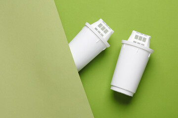 Cartridge filters for water filtration on a green background. Top view