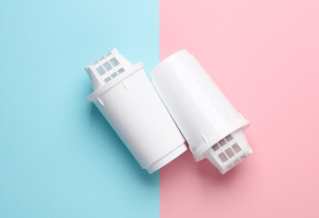 Cartridge filters for water filtration on pink blue background. Top view