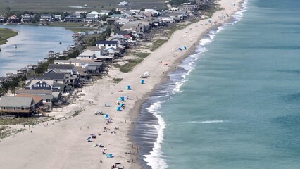 Enjoying sunny day at the beach by the ocean with people sun bathing at Pawleys Island, SC north of...