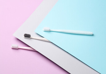Plastic toothbrushes on pastel background. Creative layout