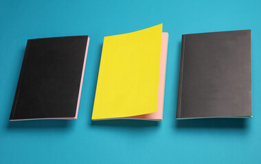 Black and yellow notepad or notebooks on a blue background
