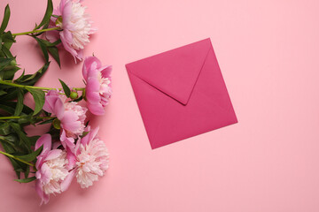 Bouquet of peonies and  envelope on pink background. Mothers Day