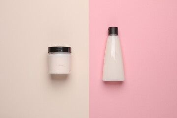 Tube and jar of cream on a pastel background. Beauty still life