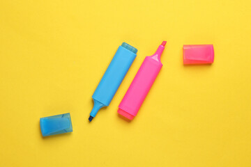 Blue and pink marker on yellow background