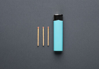 Lighter with matches on dark gray background