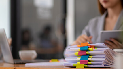 A huge stacked documents is an annual earnings summary document prepared for business people to use in attending meetings and this stacked paper is also an important document.