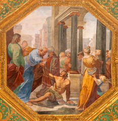 GENOVA, ITALY - MARCH 6, 2023: The fresco Saints Peter and John Healing the Lame Man in the church...