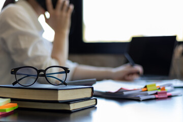 eye glasses placed on the desk are eye glasses that are prepared for people with farsightedness to...