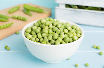 Composition with fresh green peas on wooden table