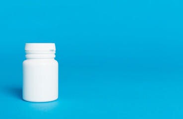 Plastic bottle for vitamins on color background