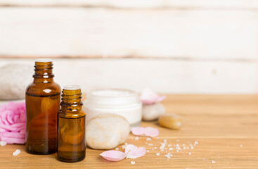 Spa composition with pink roses on wooden table