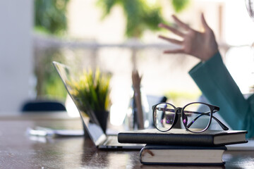 eye glasses placed on the desk are eye glasses that are prepared for people with farsightedness to...