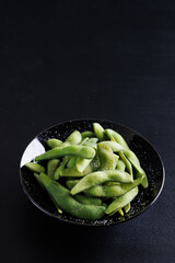 Edamame green soybeans isolated in black background