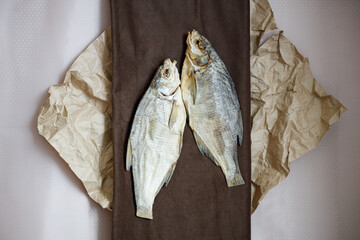 paper and dried fish on a cloth two pieces