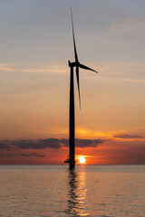 offshore wind turbine at sunset