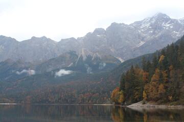 Misty view of the Zugspitze behind the Eibsee in Germany.