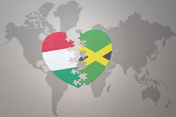 puzzle heart with the national flag of jamaica and hungary on a world map background.Concept.