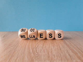 Wellness for success symbol. Concept words Wellness and Success on wooden cubes. Beautiful wooden...