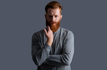 handsome unshaven man has beard and moustache on face. unshaven man with beard and moustache