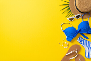 Dream vacation concept. Top view photo of straw hat, blue swimsuit, sunglasses and slippers with...