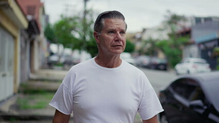 Pensive senior man walk in city sidewalk street. Contemplative thoughtful male caucasian person strolling in urban environment