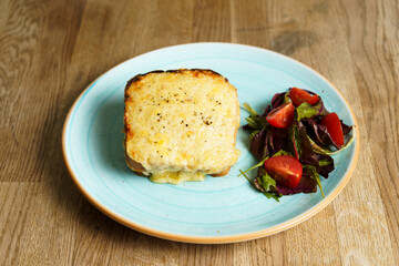 Classic french toast with cheese and ham, vegetables and honey-balsam dressing