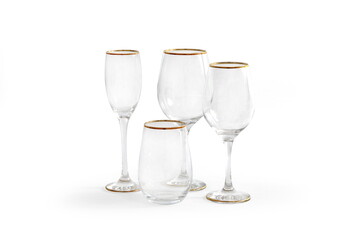 fine crystal glasses with golden rim on white background