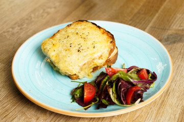 Classic french toast with cheese and ham, vegetables and honey-balsam dressing
