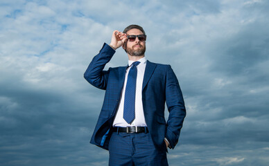 man manager in business suit. photo of man in suit. man in suit on sky background. man in suit