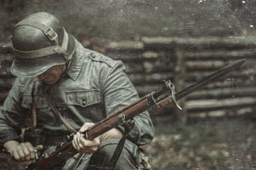 A soldier of the Finnish army during the Second World War with a gun in his hands.Bayonet knife on...