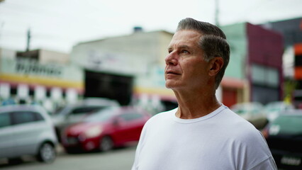 Senior man raising head to sky smiling, Hopeful expression of an older middle-age male caucasian person looking up at sky smiling with GRATITUDE