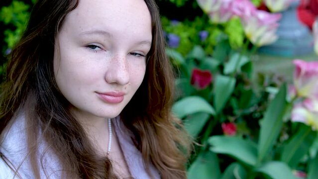 beautiful young girl woman teenager spring Outdoors beautiful pendant around her neck with a butterfly shape Lilac clothes gentle make-up female natural beauty virginity Tenderness vertical video