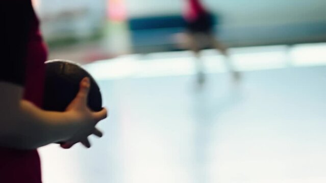 A handball player is carrying a ball