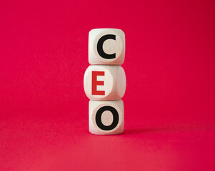 CEO - hief executive officer symbol. Concept word CEO on wooden cubes. Beautiful red background. Business and CEO concept. Copy space.