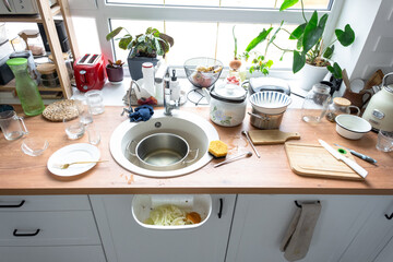 A mess in the kitchen, dirty dishes on the table, scattered things, unsanitary conditions. kitchen is untidy, everyday life