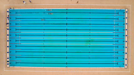Olympic pool with three swimmers training in Salvador, Bahia